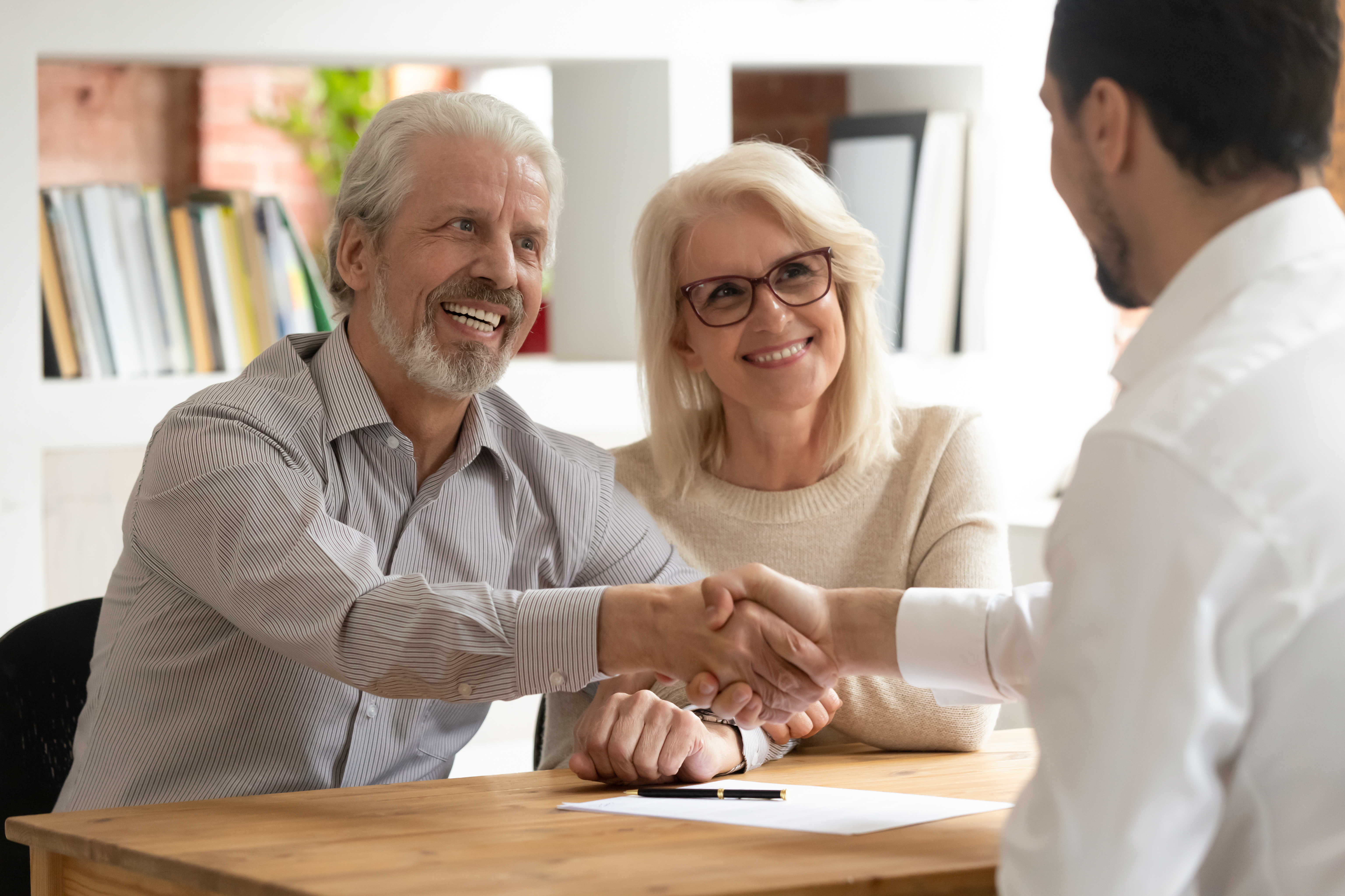 Happy Senior Old Family Couple Clients Make Financial Insurance Estate Business Deal Handshake